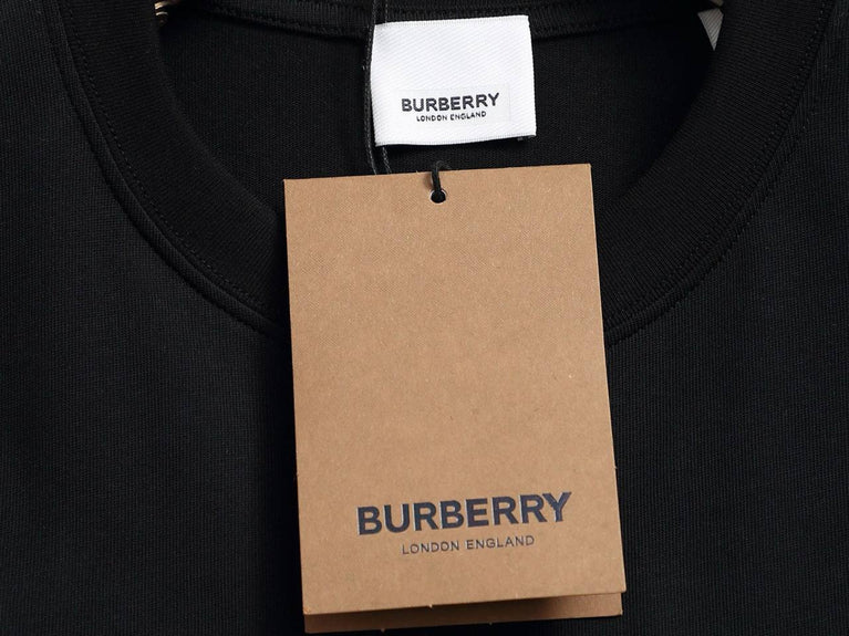 Burberry Cotton Label Oversize Tshirt displayed on a hanger with a classic black design and prominent logo.