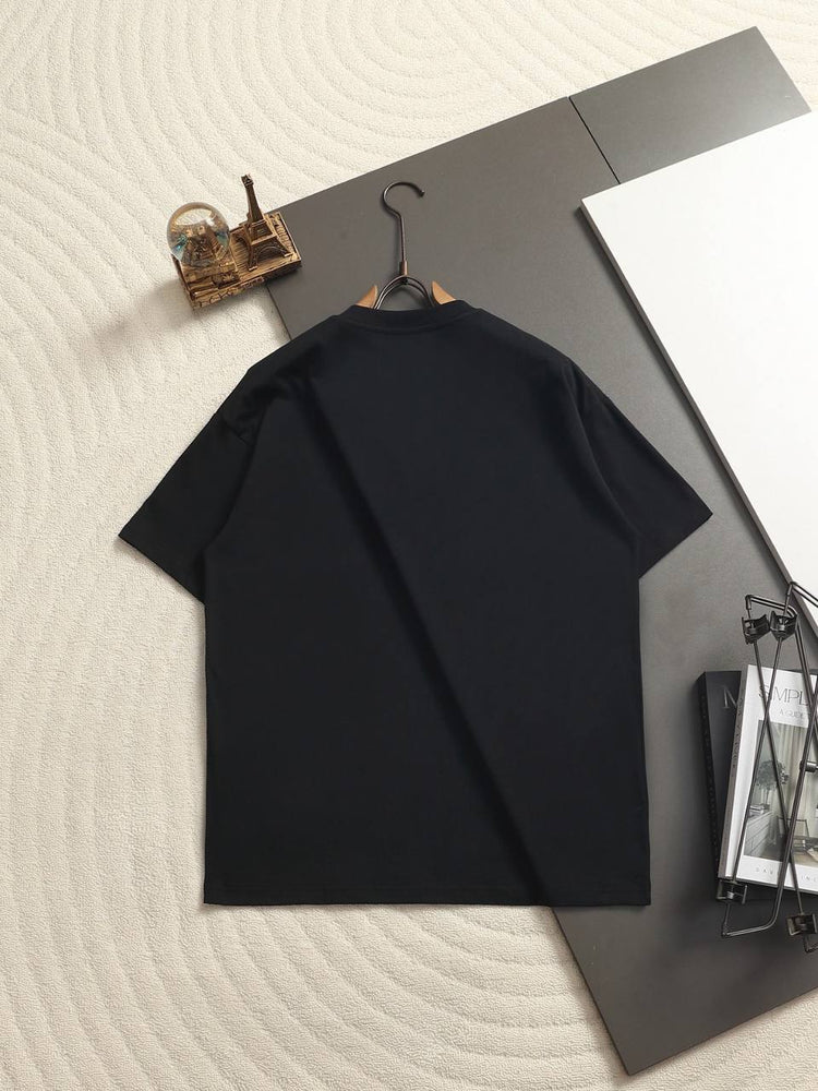 Burberry Cotton Label Oversize Tshirt displayed on a hanger with a classic black design and prominent logo.