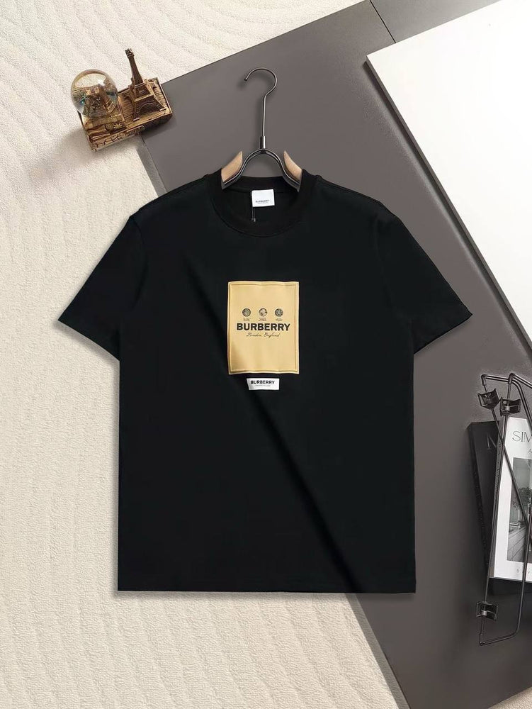 Burberry Cotton Label Oversize Tshirt displayed on a hanger with a classic black design and prominent logo.