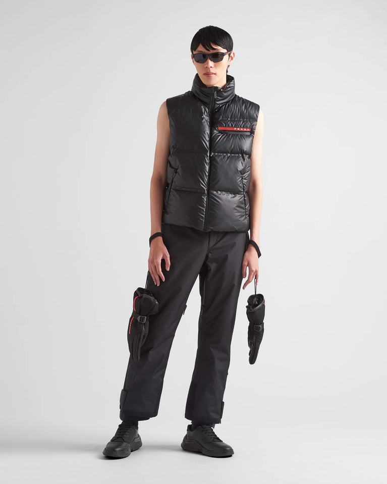 Prada Men's light Down Vest jacket, man wearing a black puffer vest and pants on a white background
