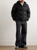 Man wearing GUCCI black puffer jacket and black pants