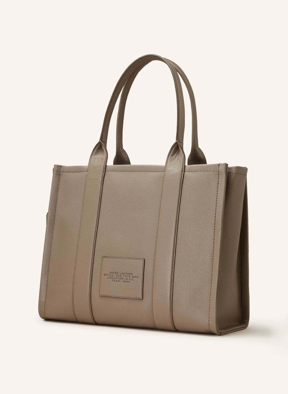 Marc Jacobs Shopper Tote Bag Leather Beige displayed on a light background, showcasing its spacious design and stylish look.