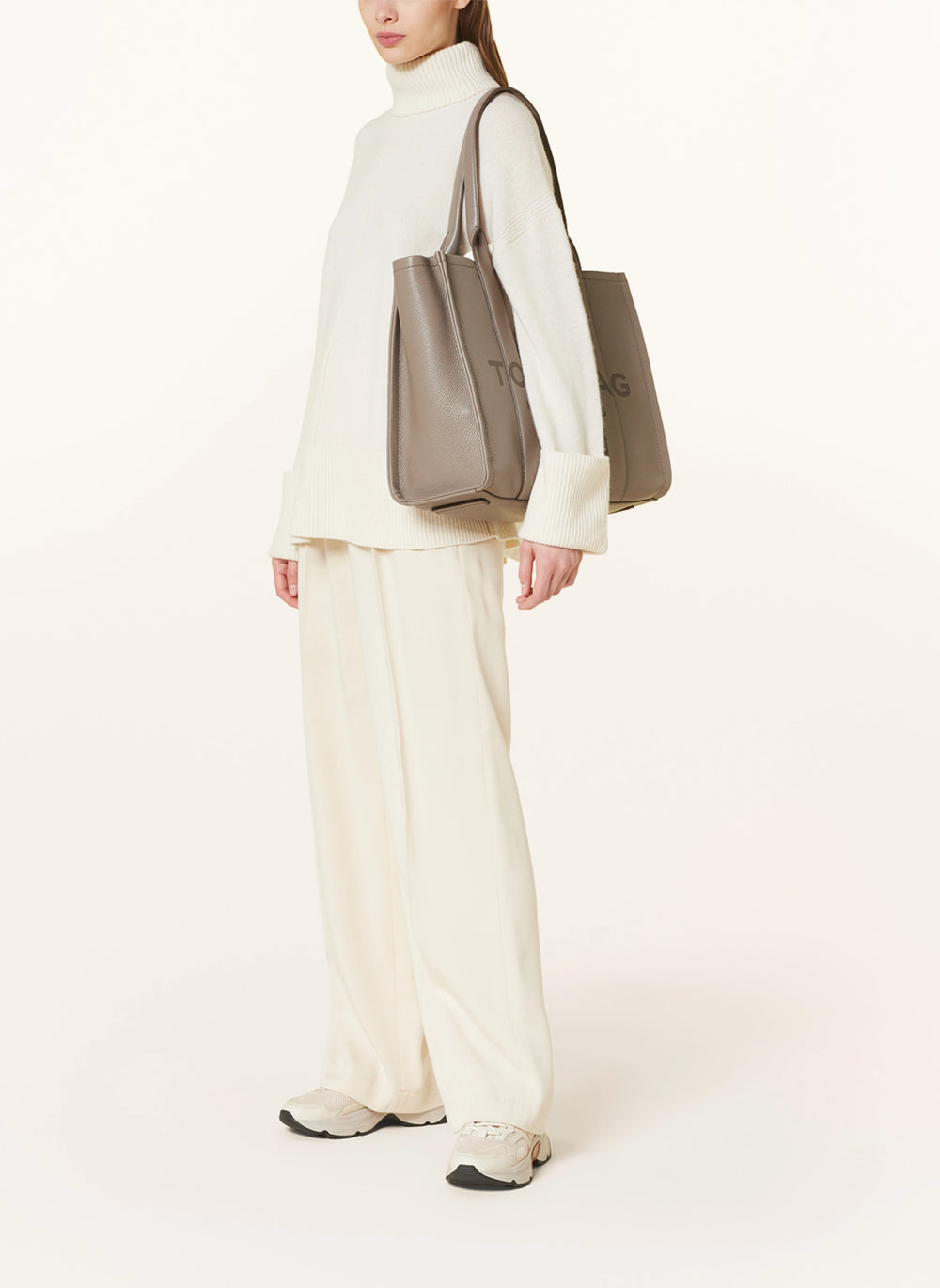 Marc Jacobs Shopper Tote Bag Leather Beige displayed on a light background, showcasing its spacious design and stylish look.
