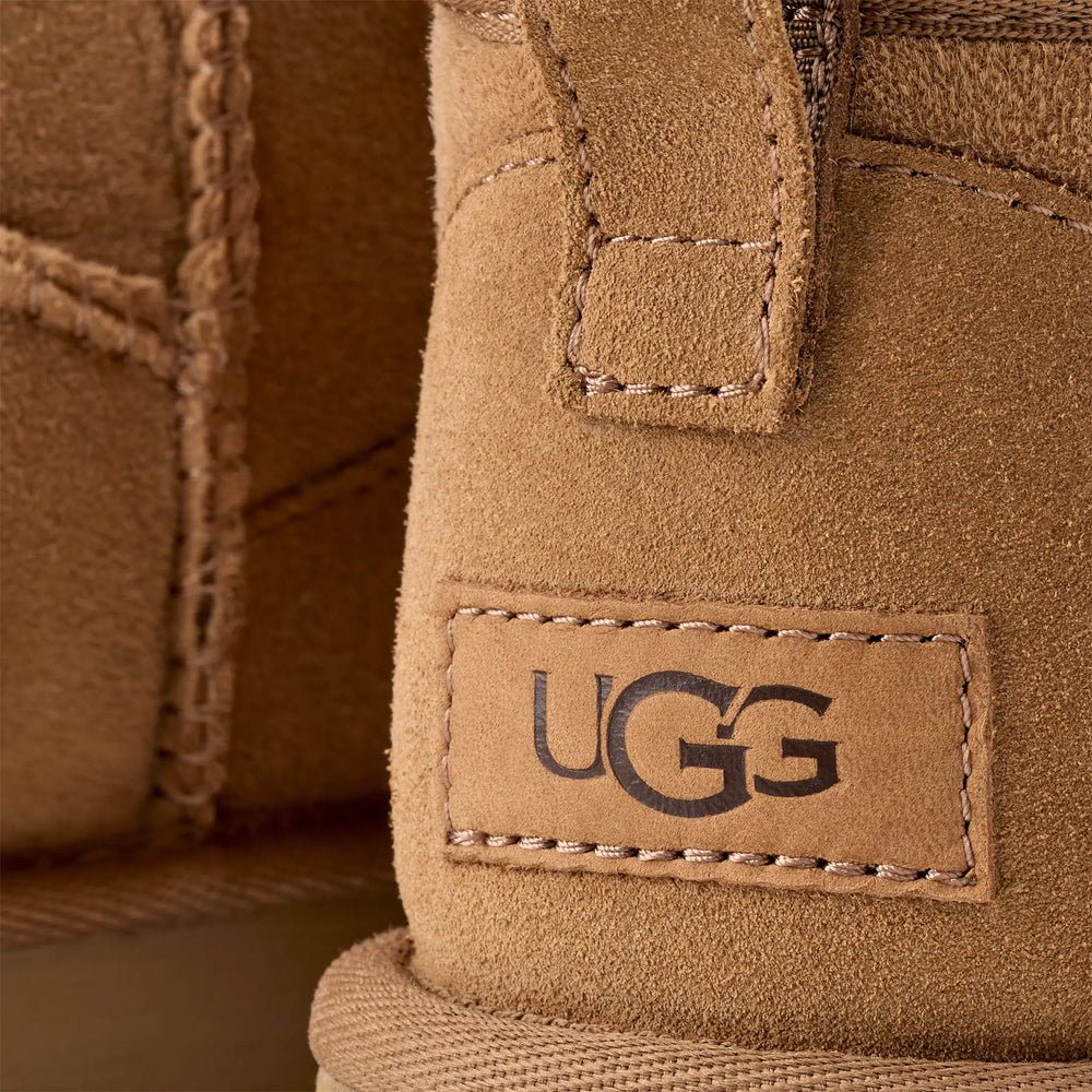 Close-up of a UGG label on a brown suede product.UGG Classic Ultra Mini Women's Warm Wool Snow Boots in volonka shop