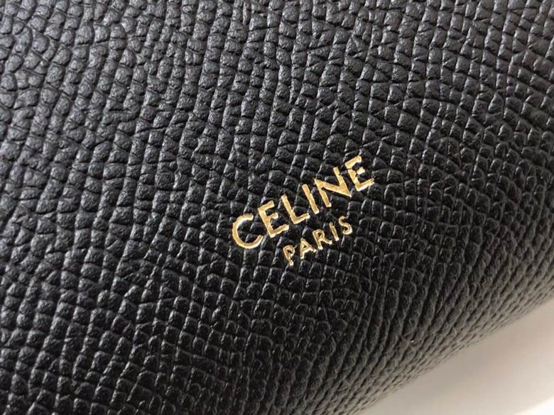 Close-up of a black textured surface with 'CELINE PARIS' logo.