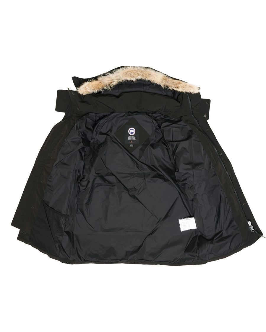 Black winter jacket with fur-lined hood on a white background. Canada Goose Wyndham Parka with Fur jacket