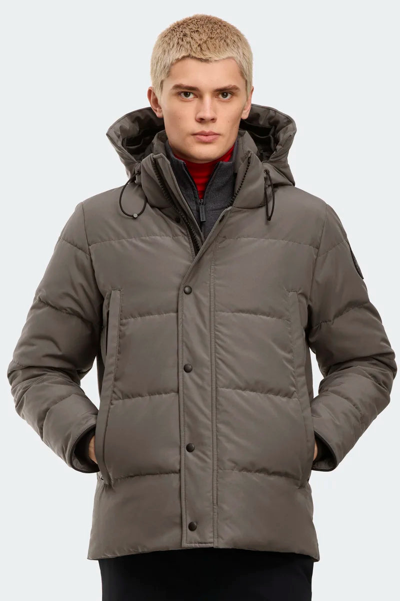 Man wearing a gray winter coat with a hood, Canada Goose Wyndham Parka Goose Men's Winter Jacket at Volonka. 