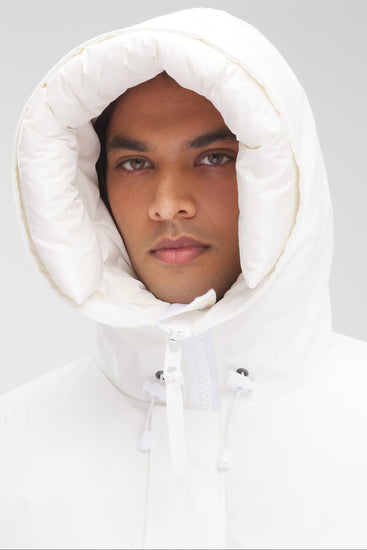 Man wearing a white hooded jacket, Canada Goose Paradigm Chilliwack Bomber Unisex Down Jacket at Volonka store.