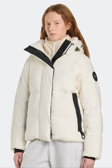 Woman wearing a white puffer jacket. Canada Goose Junction Parka Black Label Unisex Winter Jacket