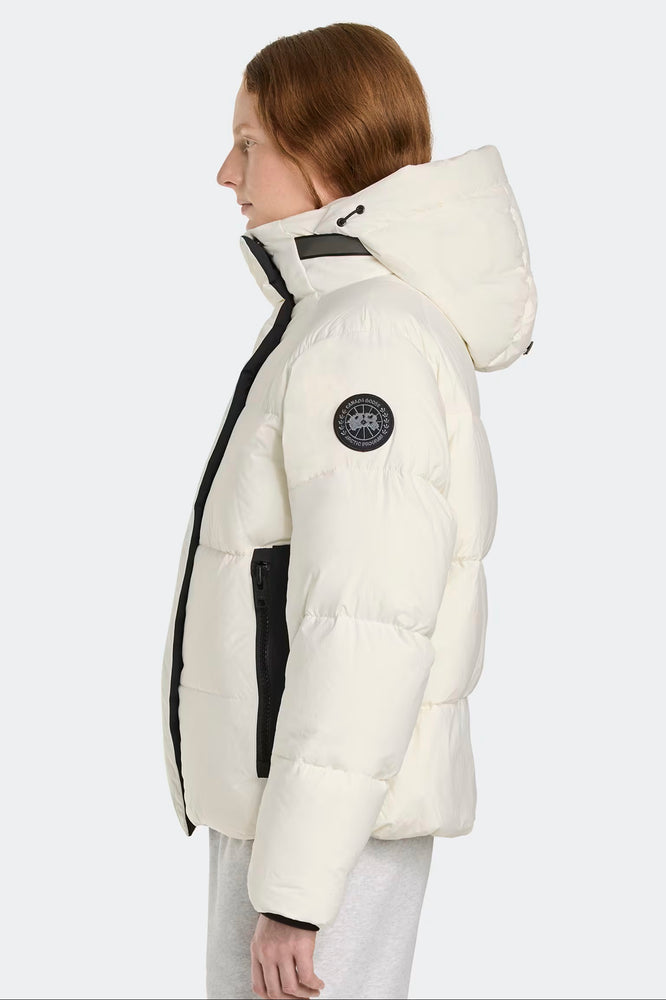 Woman wearing a white puffer jacke. Canada Goose Junction Parka Black Label Unisex Winter Jacket at Volonka store.
