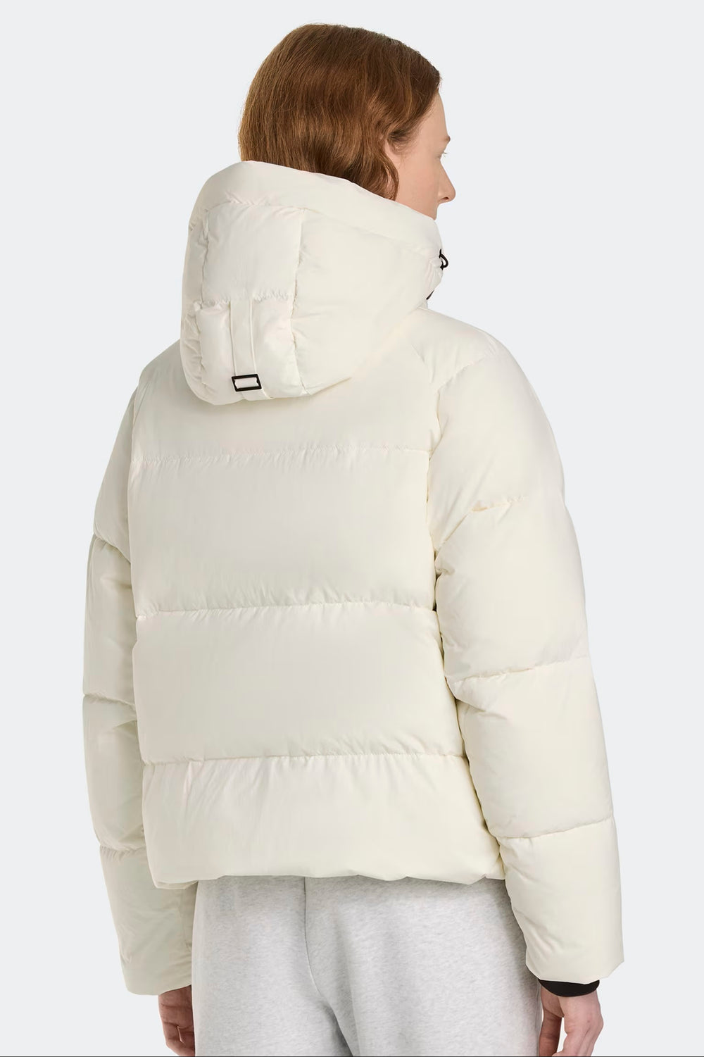 Woman wearing a white puffer jacket. Canada Goose Junction Parka Black Label Unisex Winter Jacket