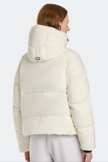 Woman wearing a white puffer jacket. Canada Goose Junction Parka Black Label Unisex Winter Jacket