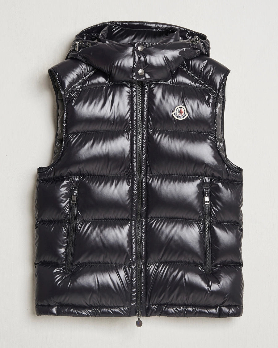 Moncler unisex Bormes down vest jacket. Black puffer vest with a brand logo on a light gray background