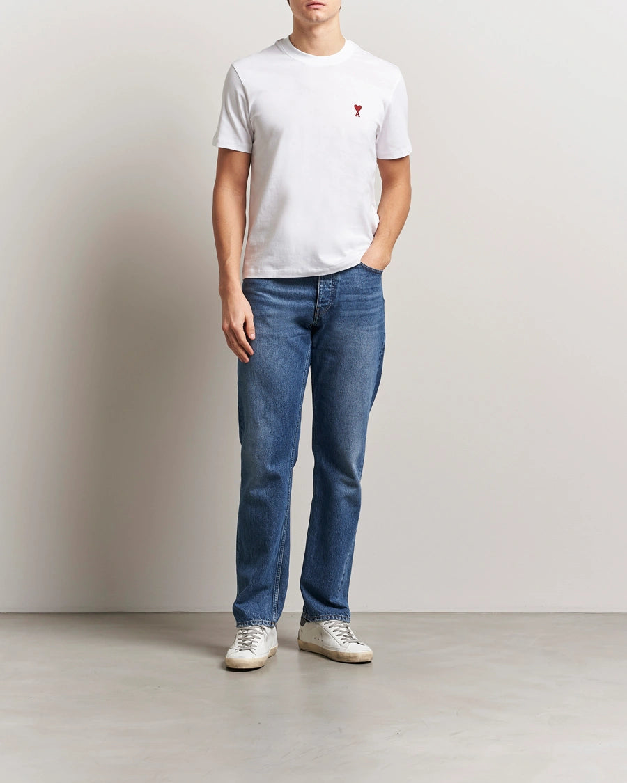 AMI Paris Heart Logo Men Tshirt featuring a white color and a red heart logo on the chest.