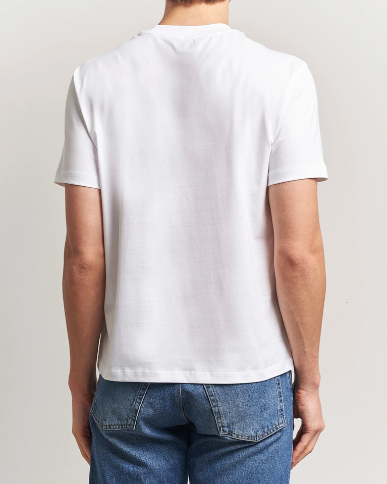 AMI Paris Heart Logo Men Tshirt featuring a white color and a red heart logo on the chest.