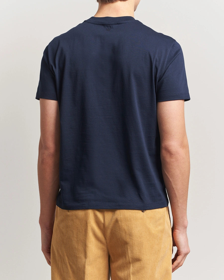 AMI Paris Heart Logo Men Tshirt in navy blue with red heart logo on chest.