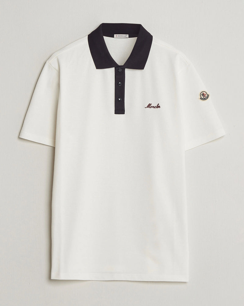 Moncler Men Signature Logo Polo displayed on a neutral background, featuring a classic collar and signature logo.