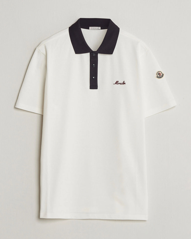 Moncler Men Signature Logo Polo displayed on a neutral background, featuring a classic collar and signature logo.