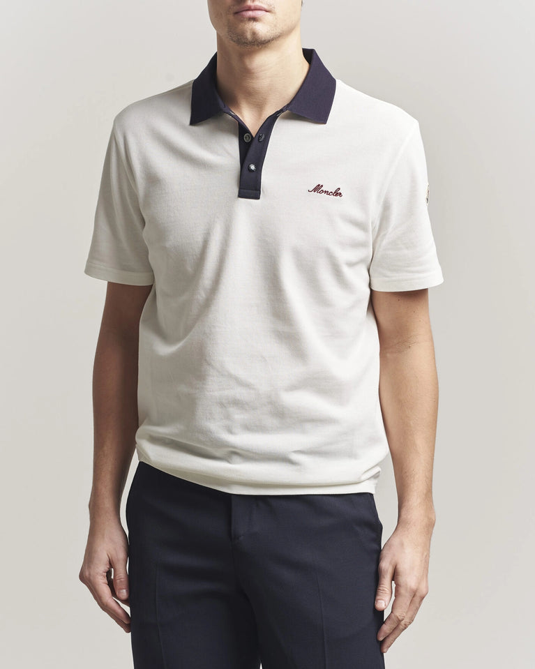 Moncler Men Signature Logo Polo displayed on a neutral background, featuring a classic collar and signature logo.