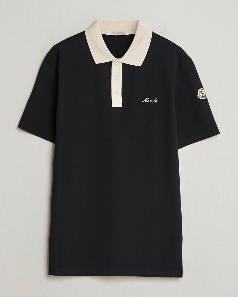Moncler Men Signature Logo Polo displayed on a neutral background, featuring a classic collar and signature logo.