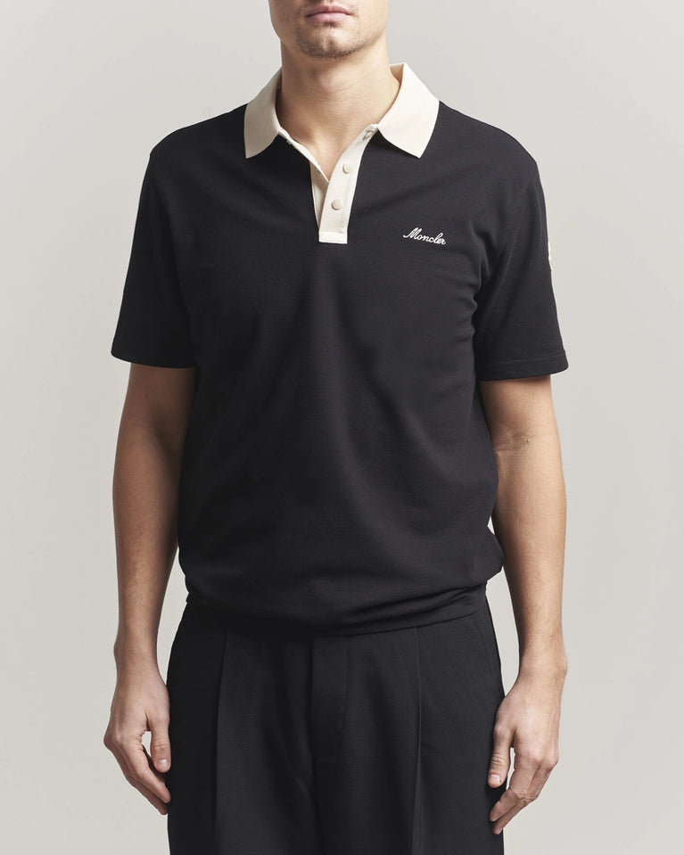 Moncler Men Signature Logo Polo displayed on a neutral background, featuring a classic collar and signature logo.