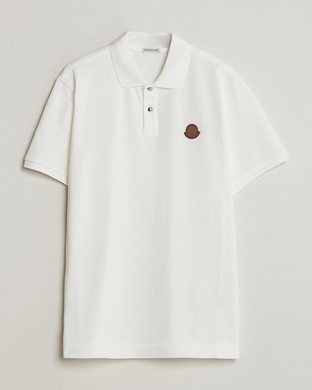 Moncler Luxury Logo Polo Shirt in white with logo on the chest and classic polo design.