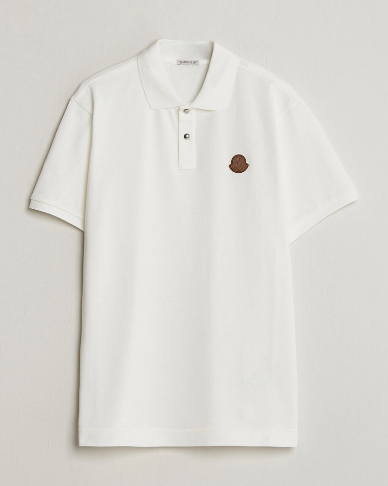 Moncler Luxury Logo Polo Shirt in white with logo on the chest and classic polo design.