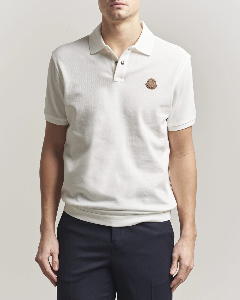 Moncler Luxury Logo Polo Shirt in white with logo on the chest and classic polo design.