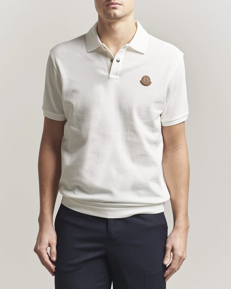 Moncler Luxury Logo Polo Shirt in white with logo on the chest and classic polo design.