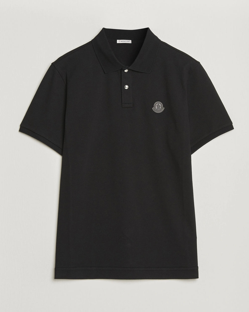 Moncler Luxury Logo Polo Shirt in black with logo on the chest and classic polo design.