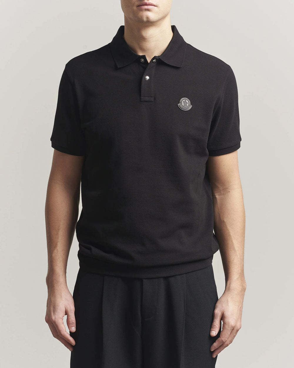 Moncler Luxury Logo Polo Shirt in black with logo on the chest and classic polo design.