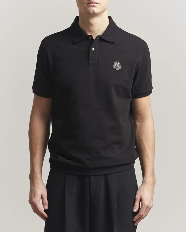Moncler Luxury Logo Polo Shirt in black with logo on the chest and classic polo design.