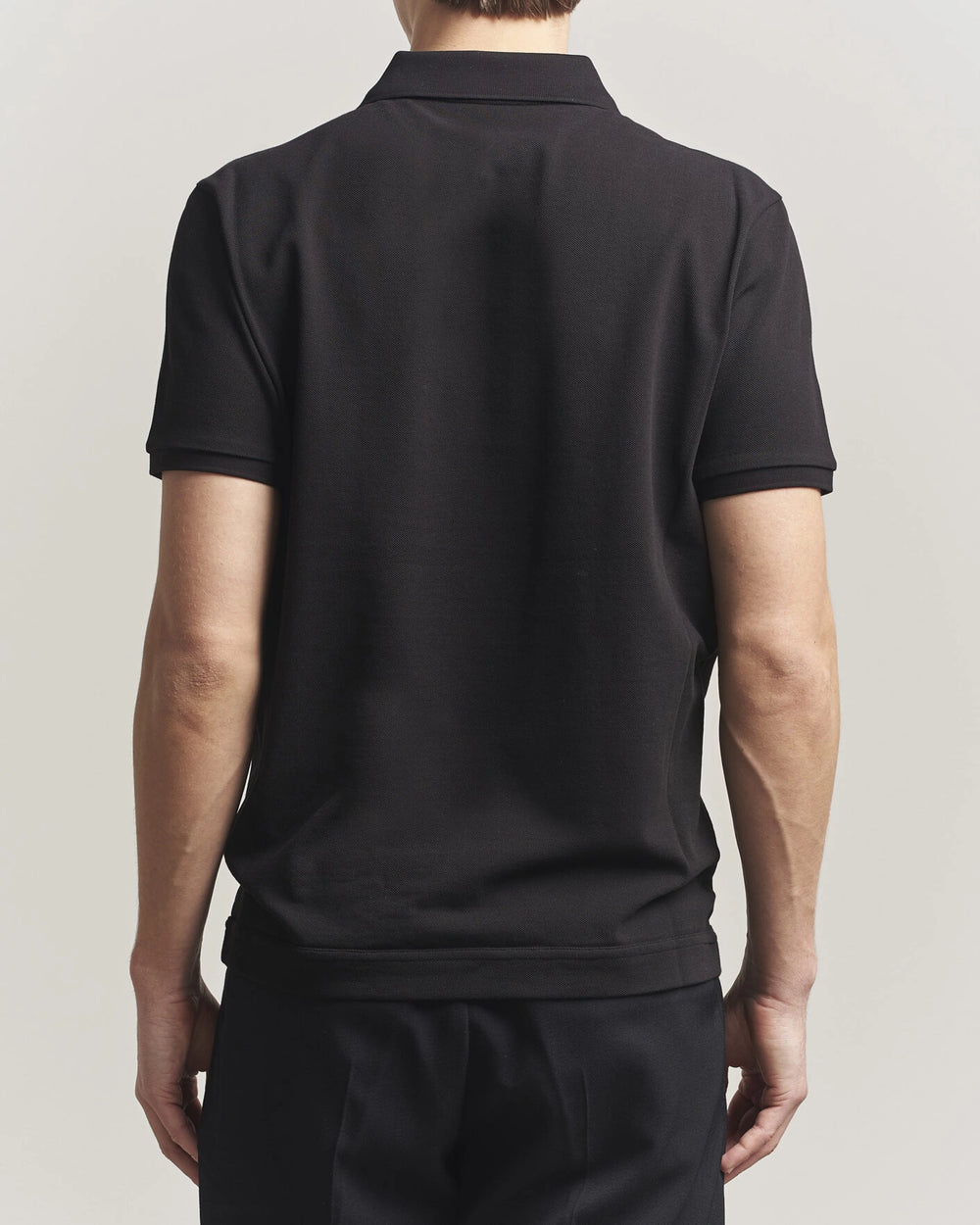 Moncler Luxury Logo Polo Shirt in black with logo on the chest and classic polo design.