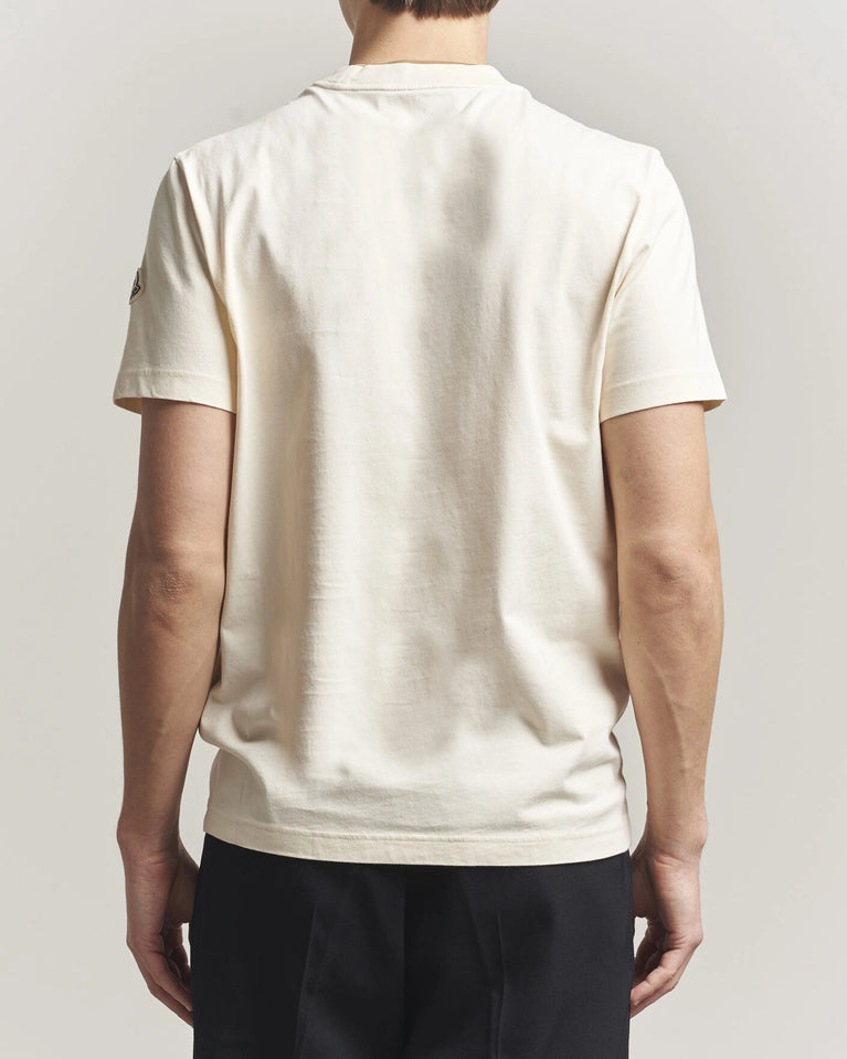 Moncler Men Signature Logo Tshirt displayed in Off white, featuring logo detail and contrasting neckline.