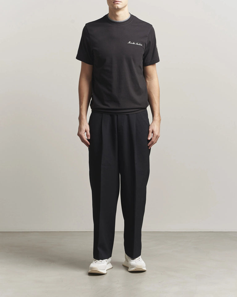 Moncler Men Signature Logo Tshirt displayed in black, featuring logo detail and contrasting neckline.