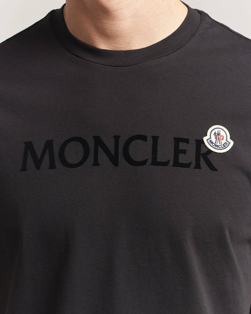 Moncler Men Lettering Logo Tshirt in black featuring a bold logo