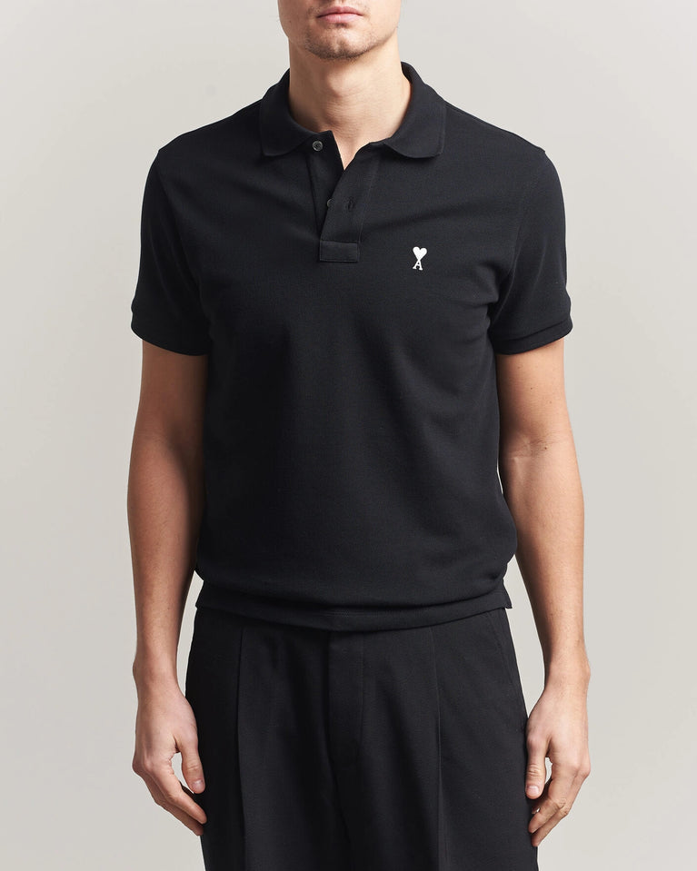 AMI Paris Heart Logo Men Polo Shirt in black, featuring a heart logo, classic and modern style.