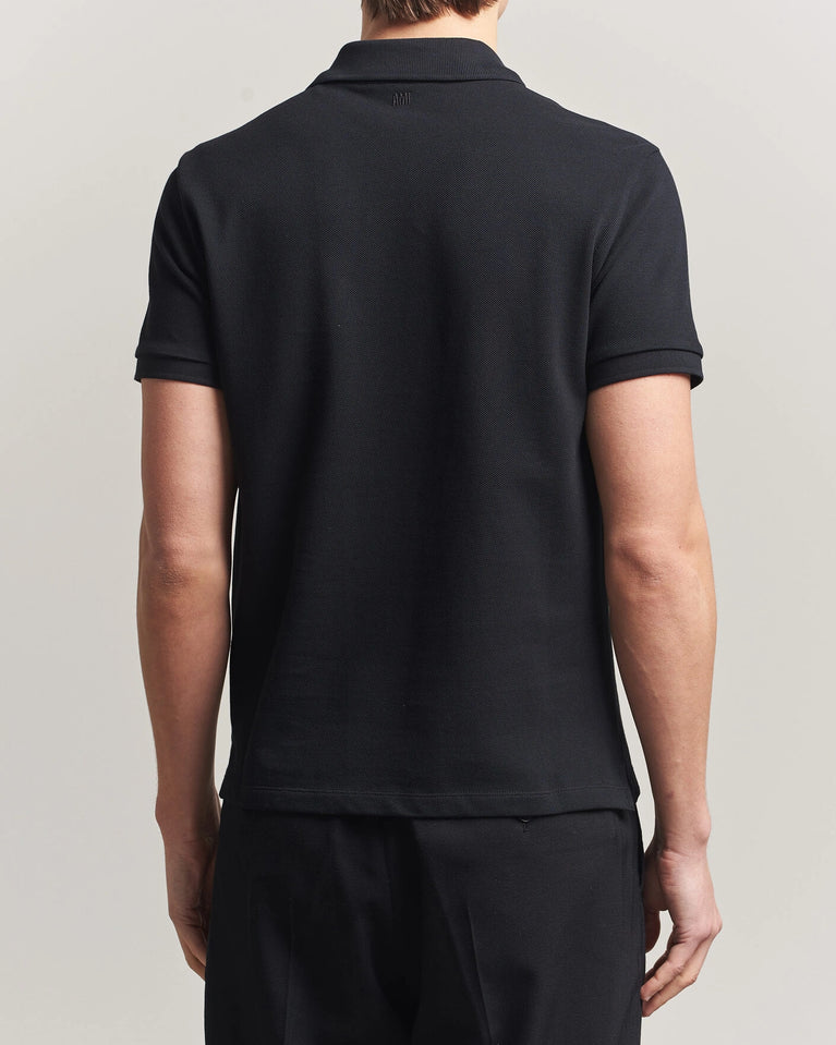 AMI Paris Heart Logo Men Polo Shirt in black, featuring a heart logo, classic and modern style.