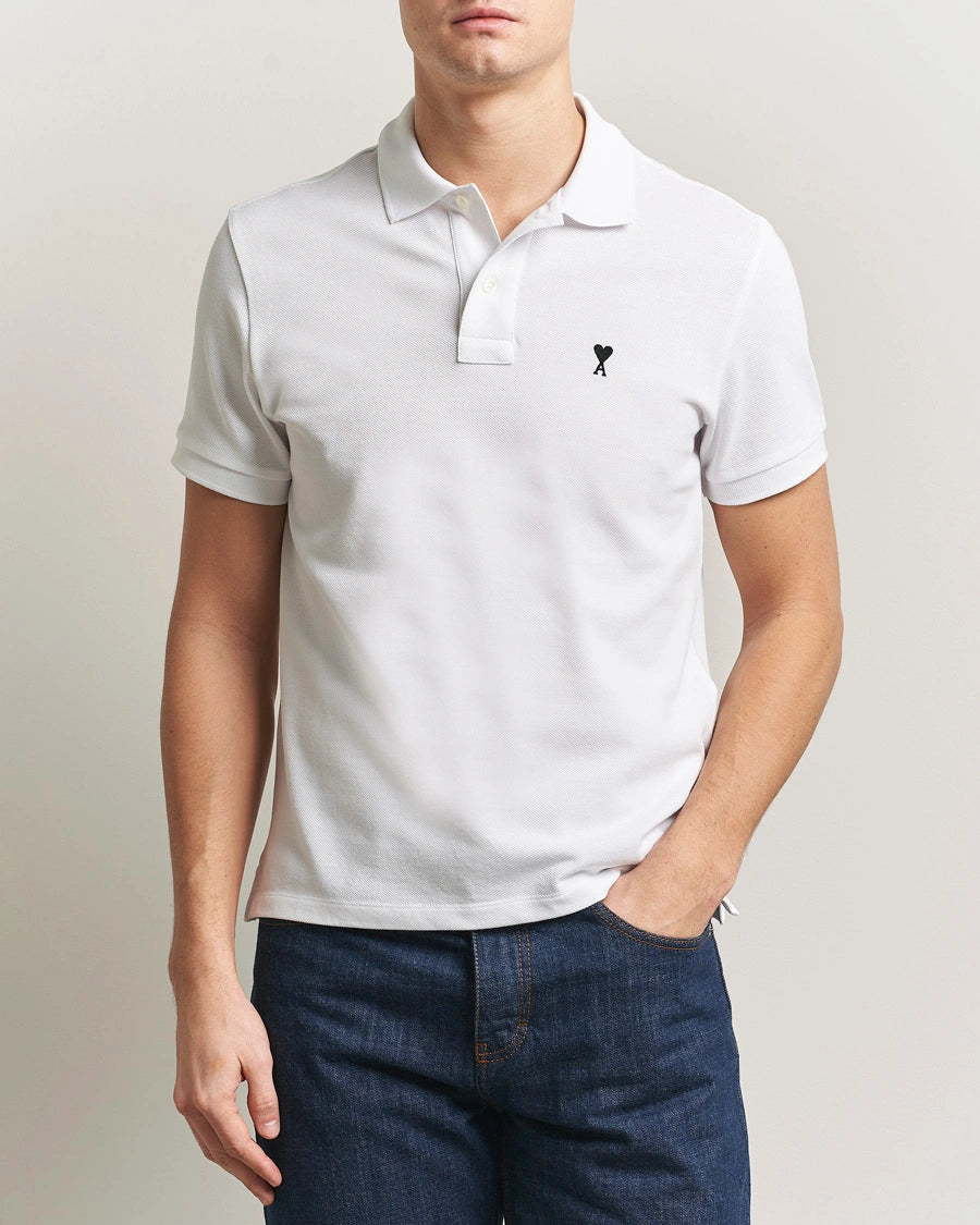 AMI Paris Heart Logo Men Polo Shirt in white featuring a signature heart logo on the chest.