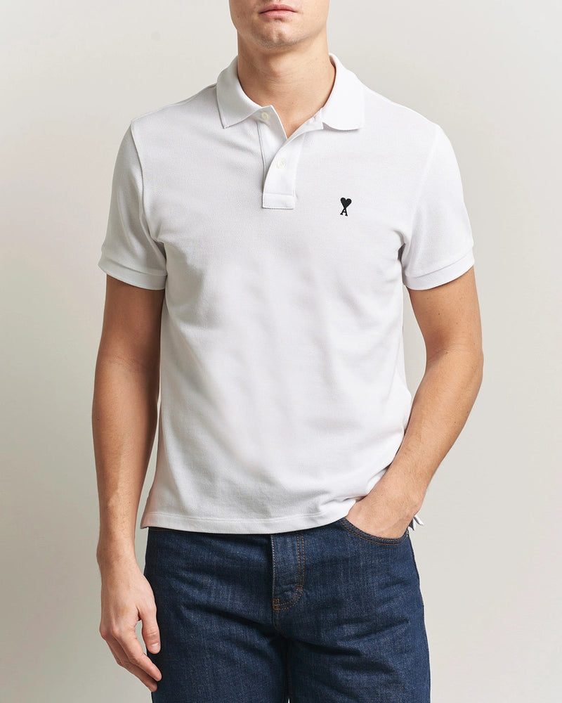 AMI Paris Heart Logo Men Polo Shirt in white featuring a signature heart logo on the chest.