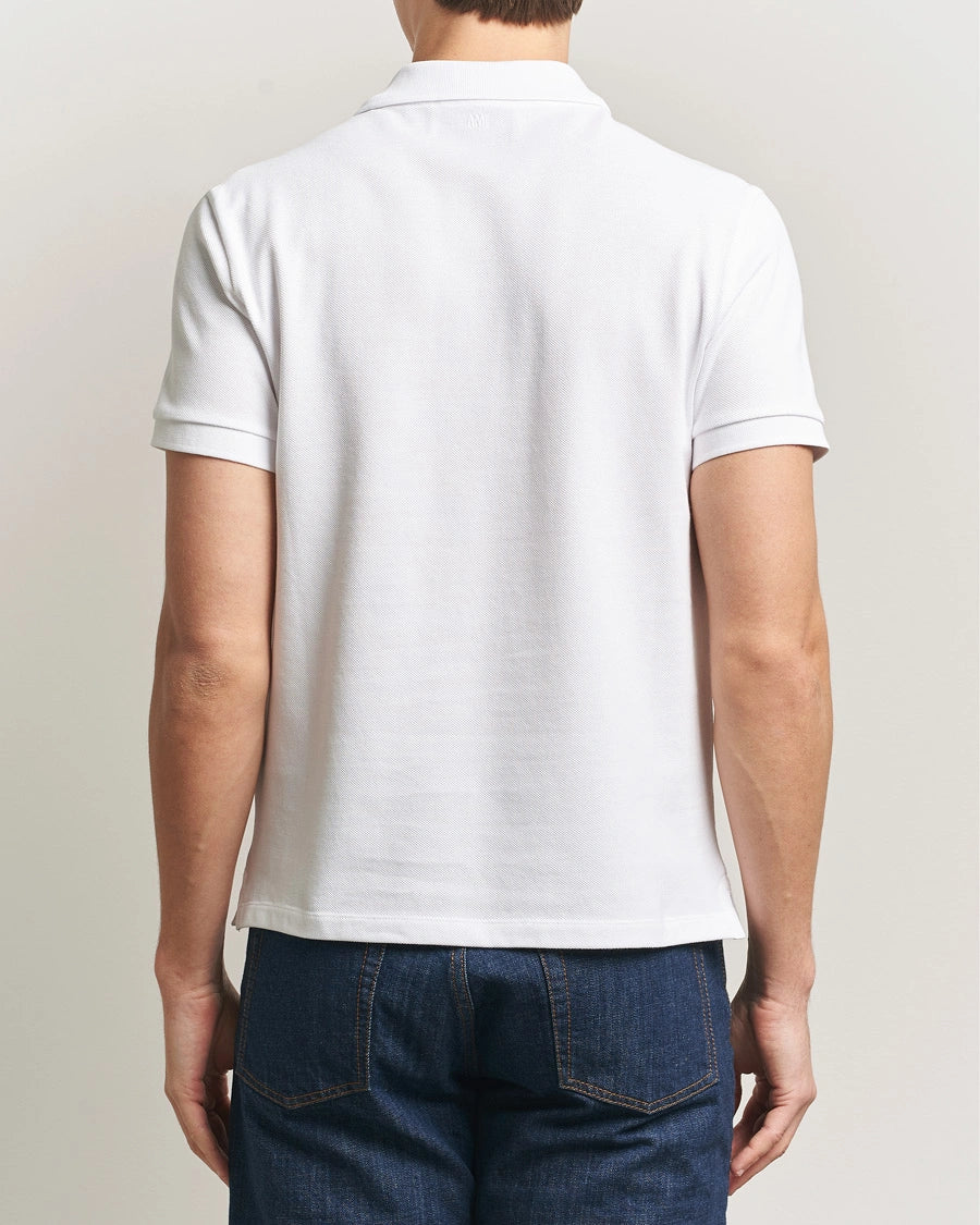 AMI Paris Heart Logo Men Polo Shirt in white featuring a signature heart logo on the chest.