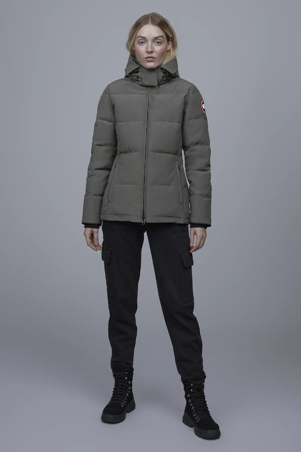 Woman wearing a green puffer jacket with a brand logo, Canada Goose Chelsea Parka Women's Down Winter Jacket at Volonka store.