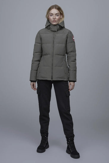 Woman wearing a green puffer jacket with a brand logo, Canada Goose Chelsea Parka Women's Down Winter Jacket at Volonka store.