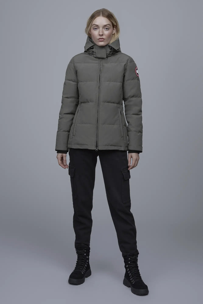Woman wearing a green puffer jacket with a brand logo, Canada Goose Chelsea Parka Women's Down Winter Jacket at Volonka store.