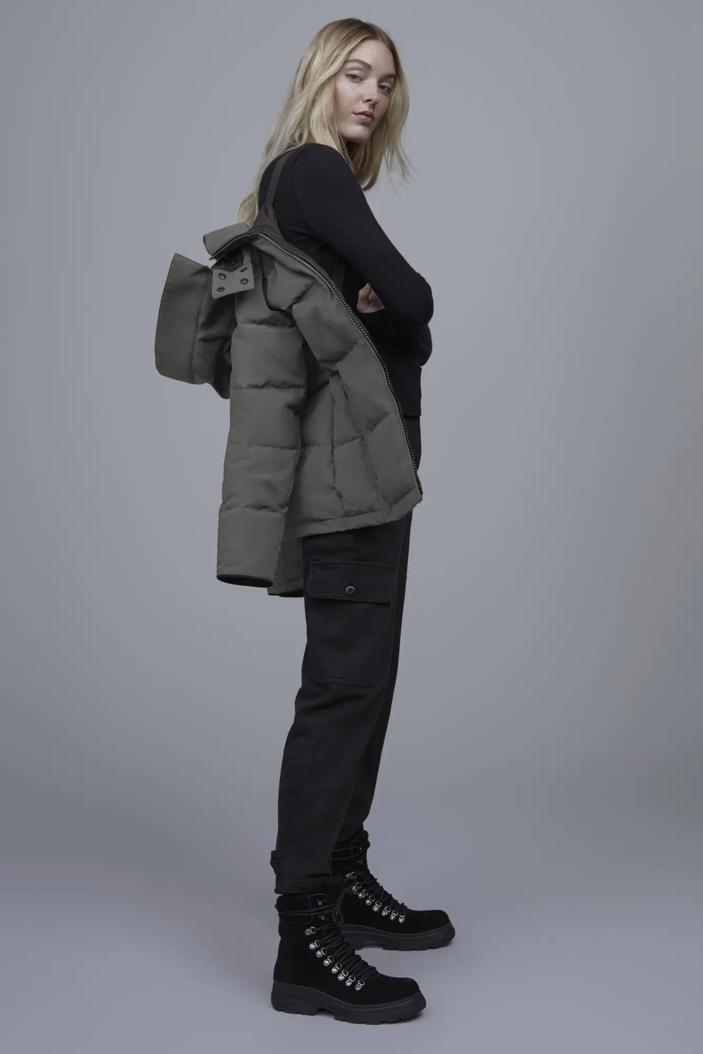 Woman wearing a green puffer Canada Goose Chelsea Parka Women's Down Winter Jacket at Volonka store.