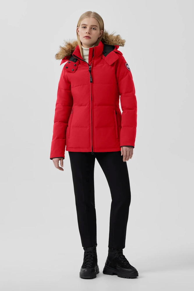 Canada Goose Chelsea Parka Women's Down Winter Jacket at Volonka store. Woman wearing a red winter coat with fur-lined hood.
