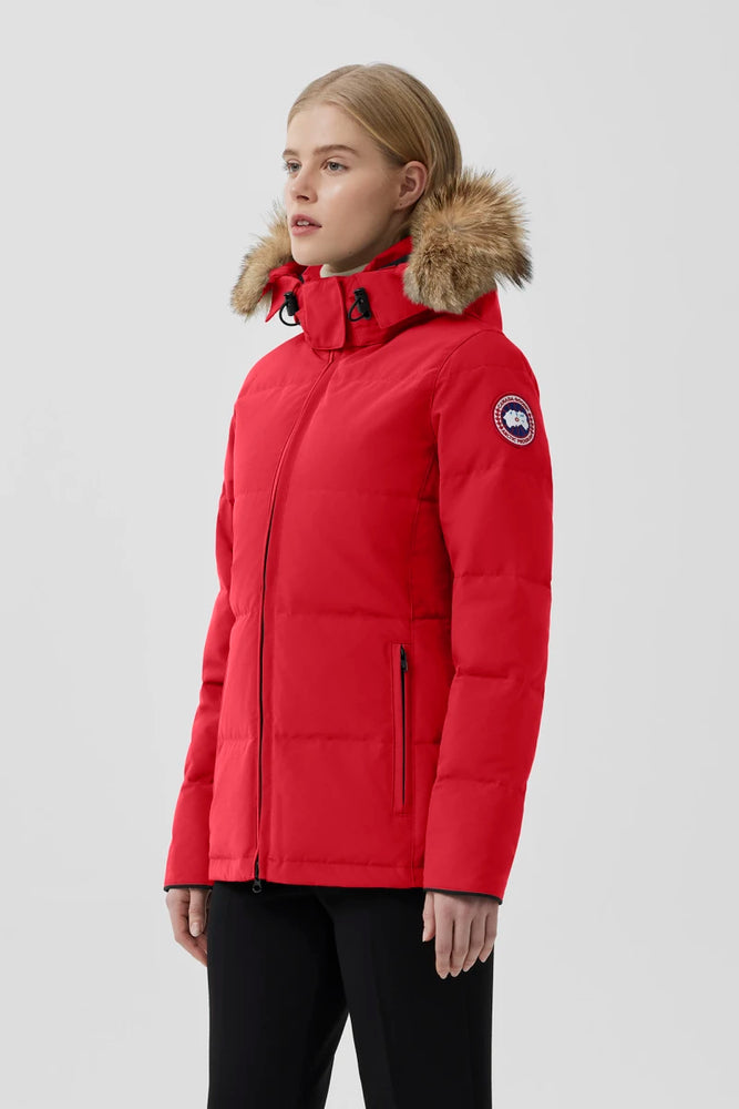 Woman wearing a red parka with a fur-lined hood, Canada Goose Chelsea Parka Women's Down Winter Jacket at Volonka store.