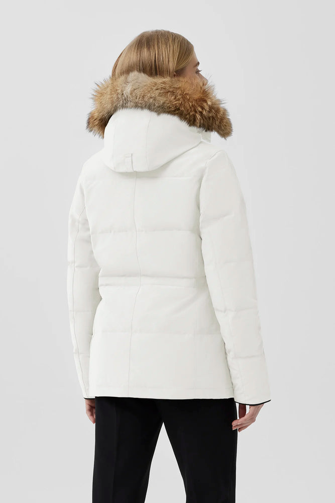 Woman wearing a white puffer jacket with fur hood, Canada Goose Chelsea Parka Women's Down Winter Jacket at Volonka store.