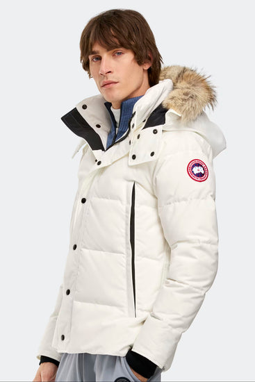 Man wearing Canada Goose Wyndham Parka Goose Men's Winter Jacket at Volonka. White Canada Goose jacket with fur hood.