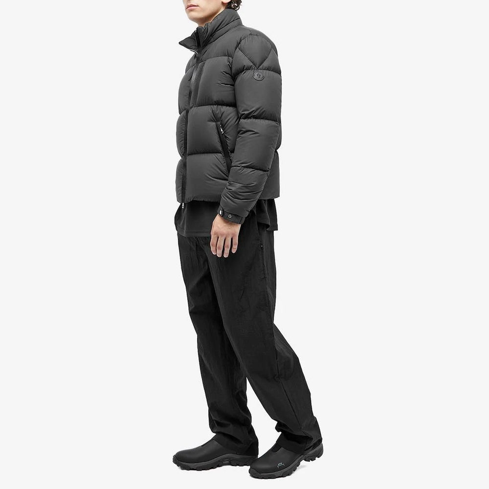 Man wearing a gray puffer jacke.Moncler Men's Besbre Padded Jacket at volonka